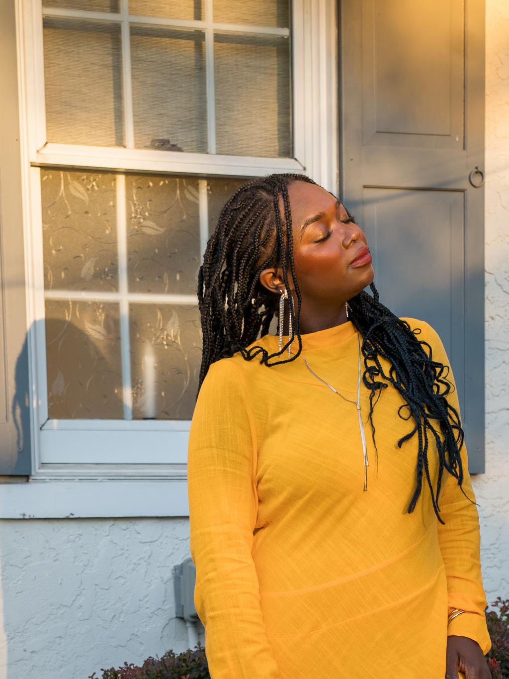 A close-up shot of a young woman wearing yellow