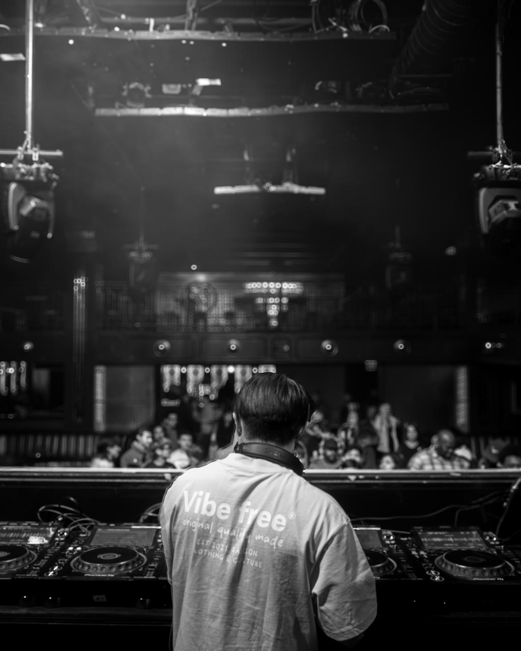 A DJ performing for a crowd in a music venue