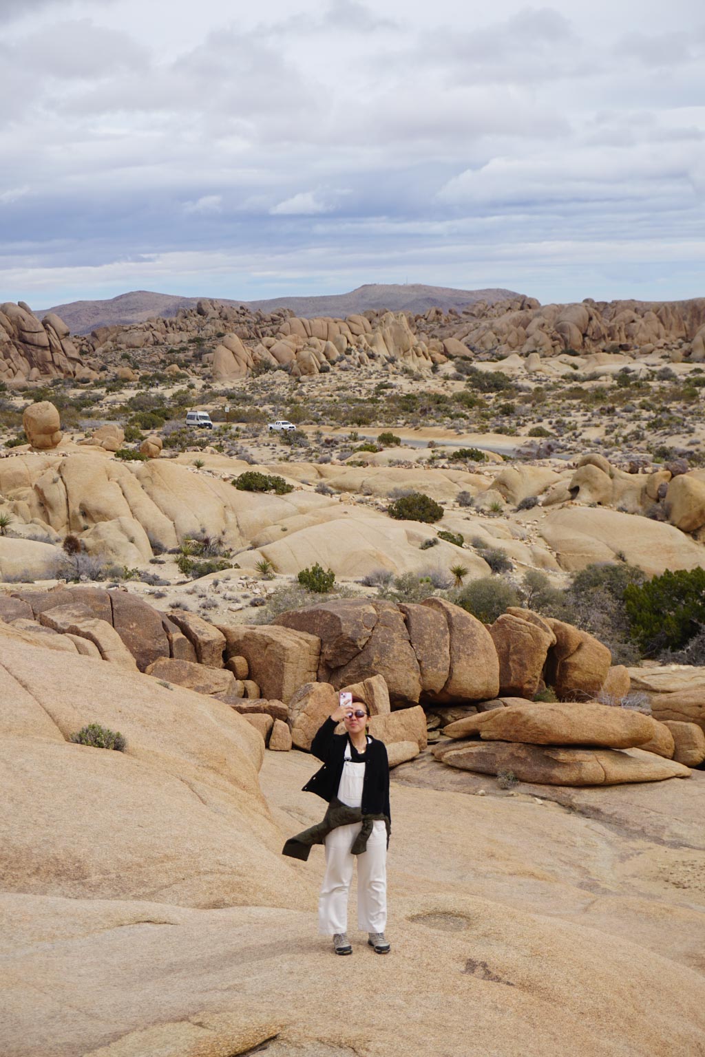 A young woman standing on big boulders