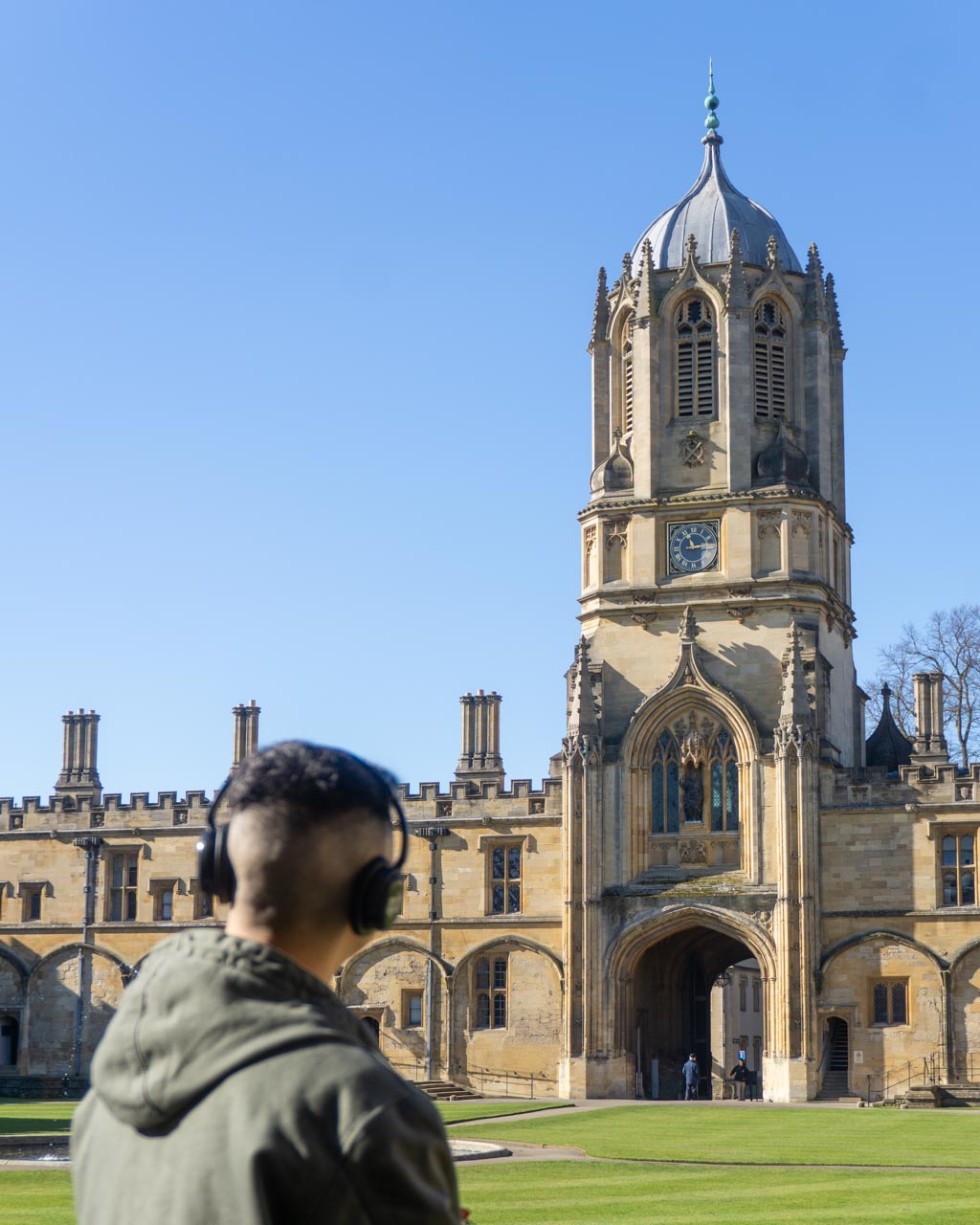 A man wearing headphones looking at a church architecture